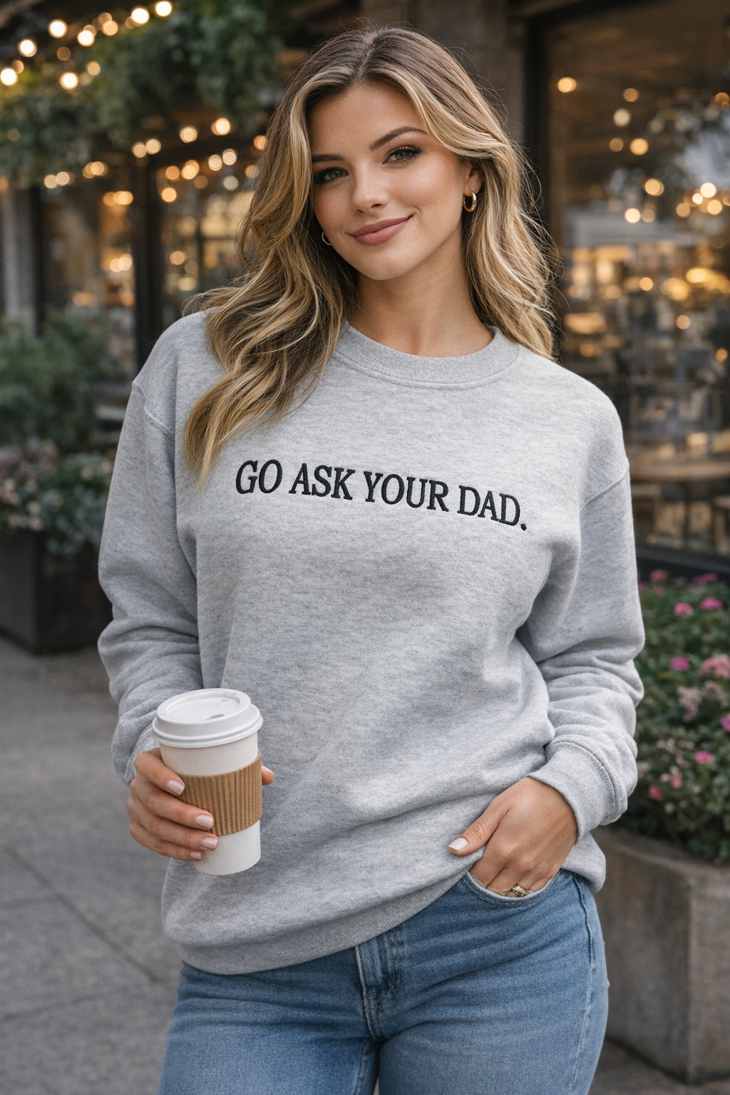 Woman wearing a gray sweatshirt with &